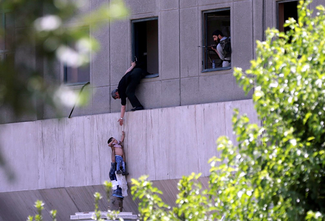 Criança é retirada pela janela durante ataque ao Parlamento do Irã, em Teerã, nesta quarta-feira (7) (Foto: Omid Vahabzadeh/Tima via Reuters)