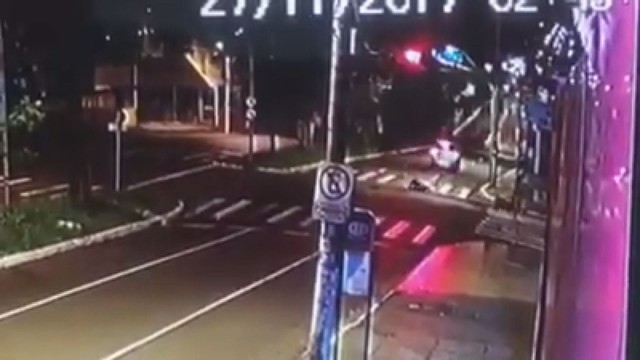 No alto é possível ver o semáforo no vermelho; abaixo, o motociclista caído no meio da avenida após bater no carro em Ribeirão Preto, SP (Foto: Divulgação).