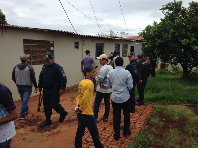 Polícia e família no terreno da casa onde aposentado morava (Foto: Osvaldo Nóbrega/TV Morena).