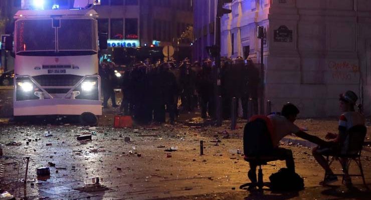 Policiais avançam durante confronto na Champs Élyseés após vitória da França (Foto: REUTERS/Gonzalo Fuentes).