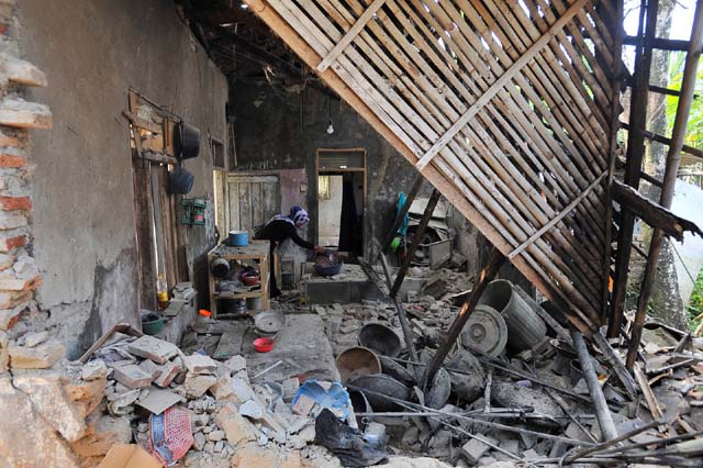 Mulher é vista dentro de casa abalada por terremoto em Pandeglang, na província de Bantn, na Indonésia — Foto: Antara Foto/Asep Fathulrahman/via Reuters.