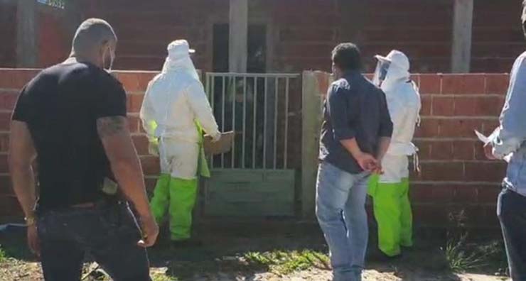 Agentes de saúde, policiais e autoridades municipais vão até casa de mulher infectada com covid-19 em Ponta Porã (MS) para entregar Boletim de Ocorrência — Foto: Secretaria de Saúde/Ponta Porã.