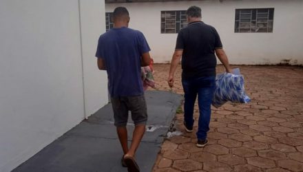Coletor de material reciclável (esq.), escoltado por um policial civil, foi indiciado por posse de arma de fogo. Foto: MANOEL MESSIAS